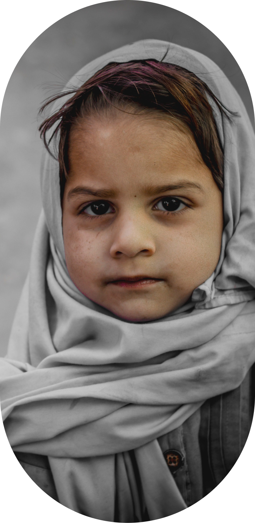 A Silent little girl in gray clothes and white hijab look at camera